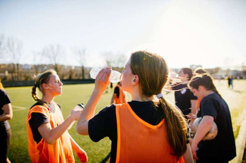 children's sport's team drinking water