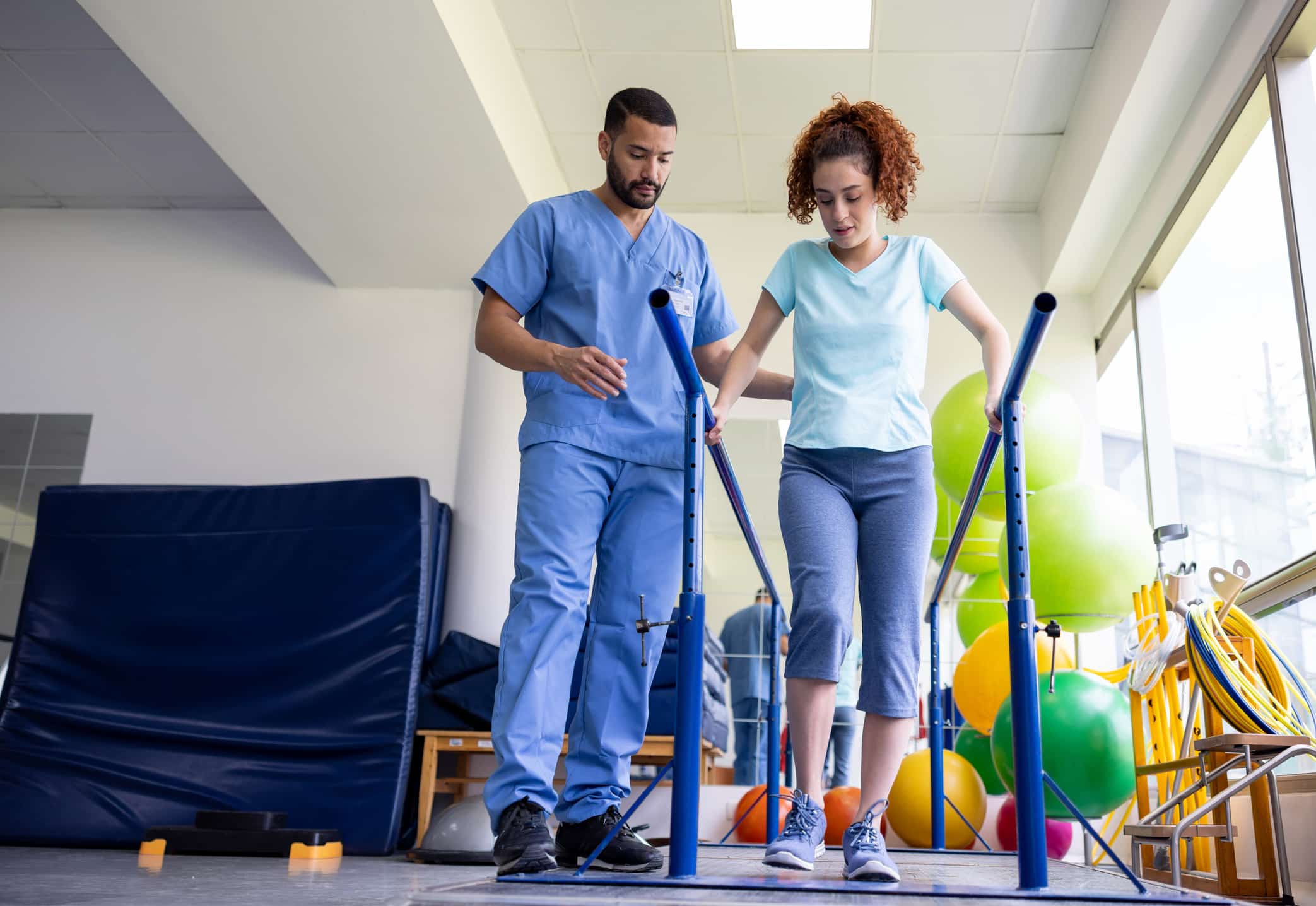Physical therapist assisting patient in leg rehabilitation.