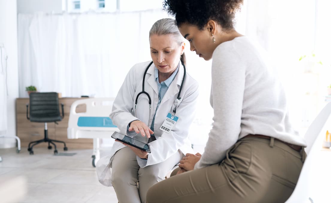 Patient talking to Urologist in doctor's office.
